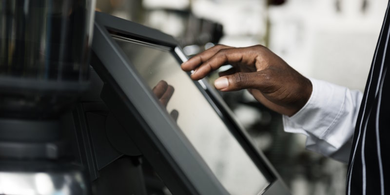 female-cashier-using-touch-screen-cash-register.jpg